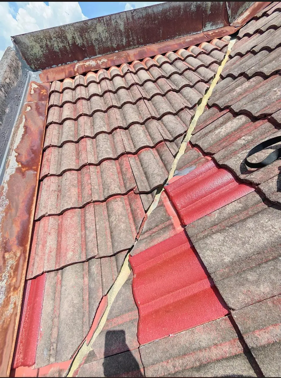 Replacement roof tiles aligned within an existing tiled roof